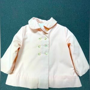 Pink little girls winter coat with buttons on front and quilted inside.